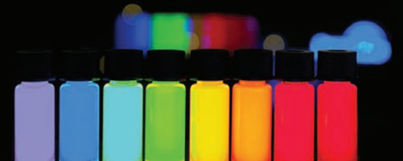 Vials of quantum dots glow in different colors under ultraviolet light. The colors of light emitted are determined by the nanoscale size and composition of the crystals in suspension. Image Credit: NASA / Mahmooda Sultana 